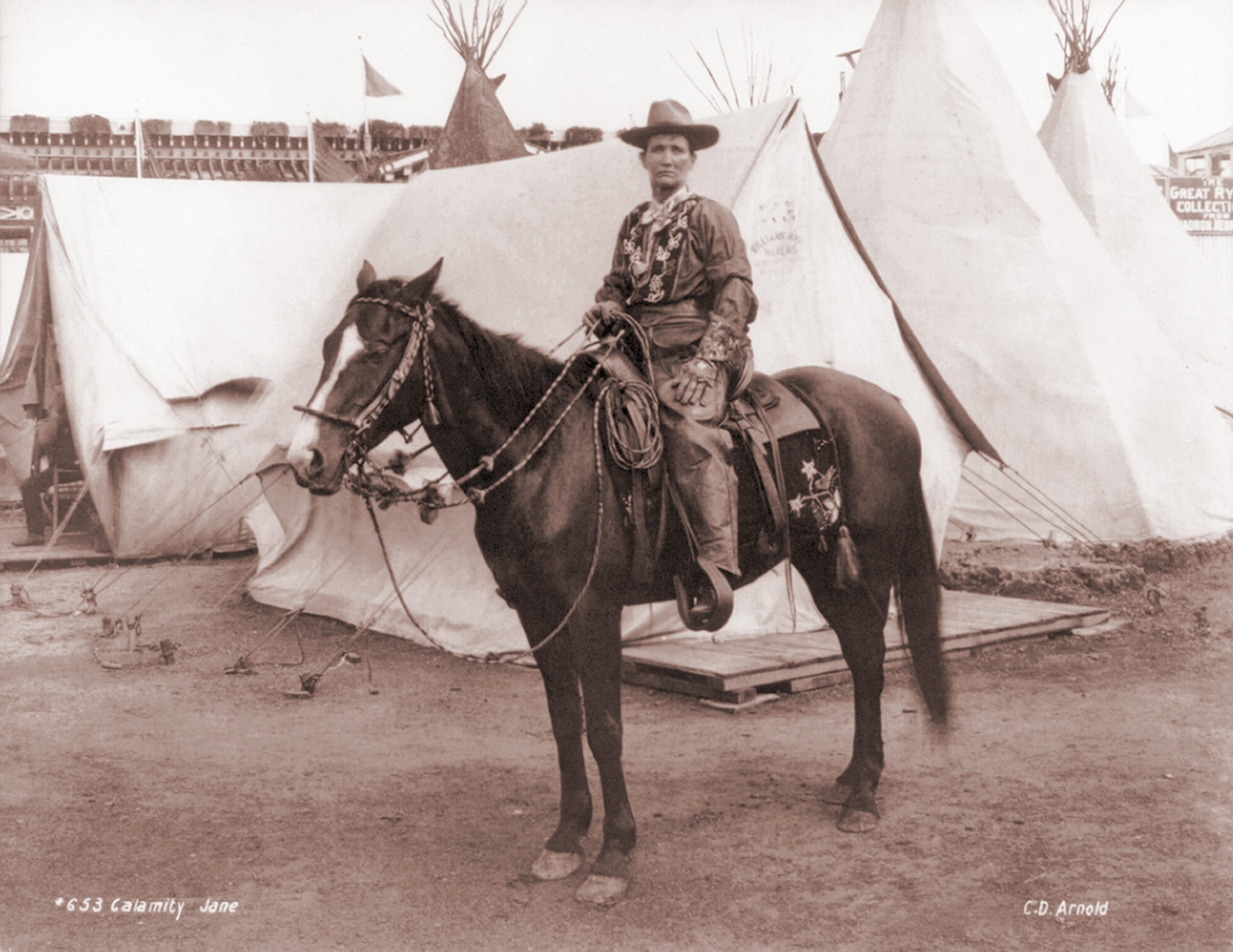 Calamity Jane (1852-1903), posing on horseback. She gained fame in the 1870s and later toured in Wild West shows. Ca. 1885.