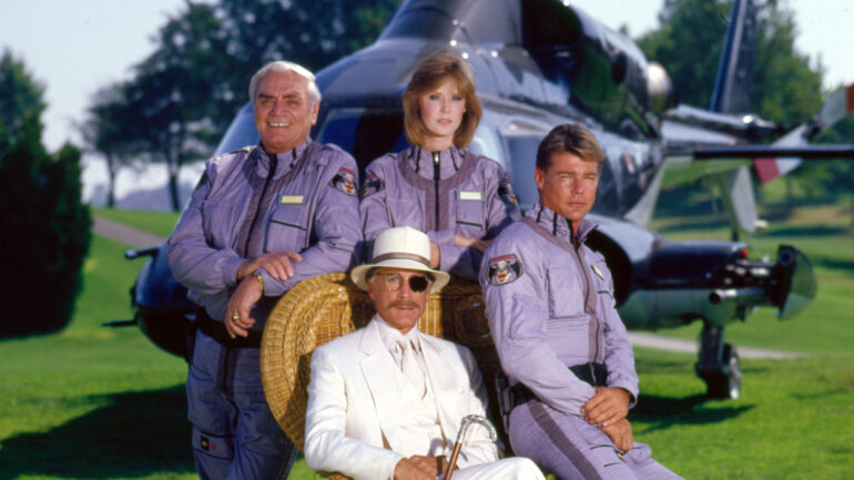 from left: Ernest Borgnine (as Dominic Santini), Jean Bruce Scott (as Caitlin O'Shannessy), Jan-Michael Vincent (as Stringfellow Hawke) and seated, Alex Cord (as Michael Archangel) in AIRWOLF 1985 Jean Bruce Scott (as Caitlin O'Shannessy) and Jan-Michael Vincent (as Stringfellow Hawke) on AIRWOLF.