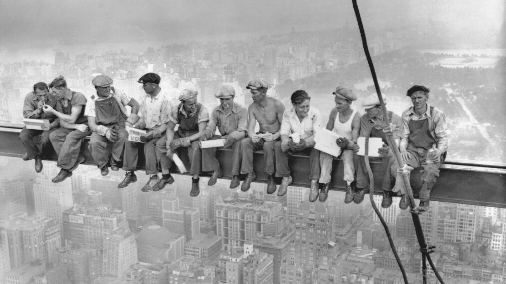 While New York's thousands rush to crowded restaurants and congested lunch counters for their noon day lunch, these intrepid steel workers atop the 70 story RCA building in Rockefeller Center get all the air and freedom they want by lunching on a steel beam with a sheer drop of over 800 feet to the street level. The RCA building is the largest office building in terms of office space in the world. (original caption). Image taken 9/20/32; filed 9/29/32.
